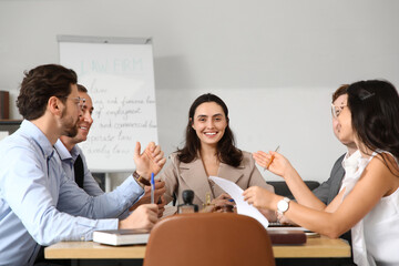 Group of lawyers working at table in office