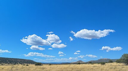 clear blue sky with a few clouds. The sky is very bright and the clouds are scattered throughout