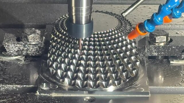 The 5-axis CNC milling machine cutting the automotive part with solid ball end mill tool.