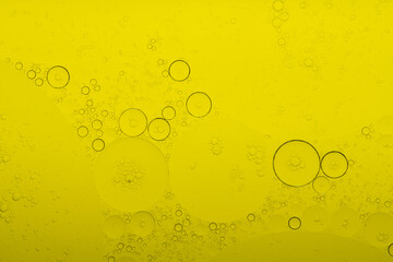 Macro microscope yellow bubble texture, Close-up Yellow bubbles and drops oil background . golden Yellow water bubbles, close up golden oil drop for celebration