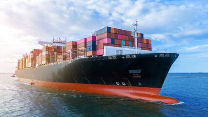 Aerial side view of cargo ship carrying container and running for export cargo yard port to custom...