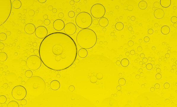Macro microscope yellow bubble texture, Close-up Yellow bubbles and drops oil background . golden Yellow water bubbles, close up golden oil drop for celebration