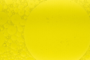 Macro microscope yellow bubble texture, Close-up Yellow bubbles and drops oil background . golden Yellow water bubbles, close up golden oil drop for celebration