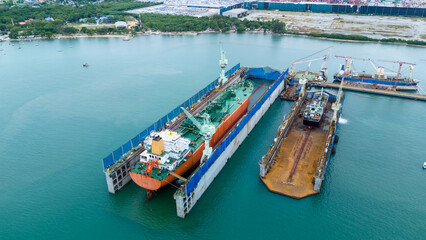 cargo container ship at dry dock concept maintenance service working in the sea. Insurance and...