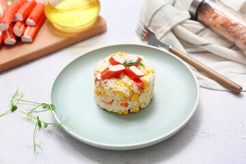 Plate of salad with crab sticks and corn on white background