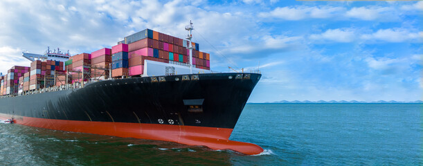 Aerial side view of cargo ship carrying container and running for export cargo yard port to custom...