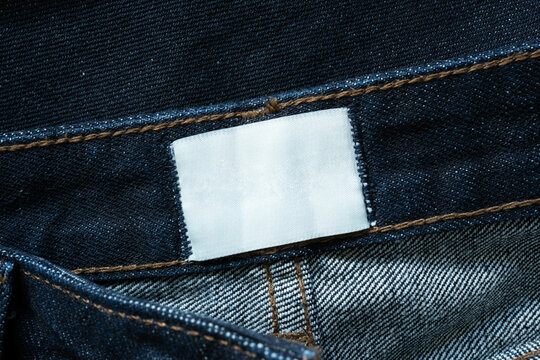 White rectangular label inside blue jeans waistband