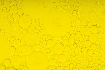 Macro microscope yellow bubble texture, Close-up Yellow bubbles and drops oil background . golden Yellow water bubbles, close up golden oil drop for celebration