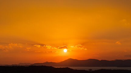 At dusk, the sun sets over the island.