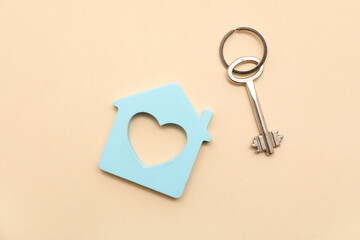House figure with key on beige background