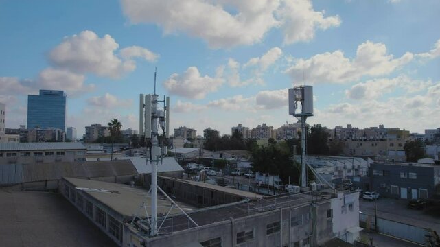 Dual cellular antenna in a small industrial area, antenna emitting non-ionizing radiation - radiation emission from cellular antennas and transmission sources can cause body health effects
