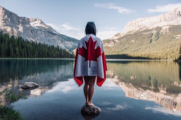 Standing in the beautiful Emerald Lake in Yoho National Park in British Columbia proudly wearing the Canadian flag