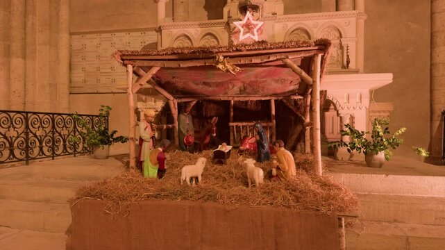 A peaceful nativity scene inside Saint-Nicolas Church in Blois, France, glowing warmly