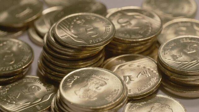 falling coins on indian currency shining golden 5 rupee coin towers , 4k ,close up, Parallax shot