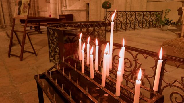 Candles lit in Church Saint-Nicolas, Blois, France, creating a peaceful, sacred mood