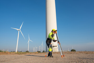 Survey in uniform Alternative energy for future. Engineers survey and checking wind turbines in...