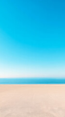 Fototapeta premium Bright clear sky above a calm ocean and sandy beach on a sunny day