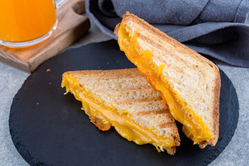 Arilled cheese sandwich. A sandwich made with melted cheddar cheese