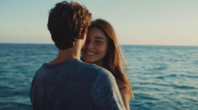 Happy couple embracing by the ocean at sunset, wearing casual summer attire, with warm light reflecting on the water, capturing joyful moments together near the sea.