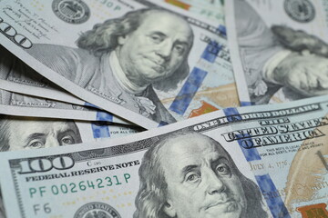 Money, US hundred dollar bills background on wooden background. Money is scattered on the table. Finance and economics concepts. Money accumulation concept. Currency saving. Investment. Copy space