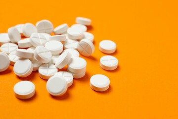 White pills on color background
