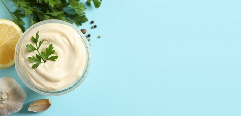 Bowl with mayonnaise and ingredients for cooking on color background