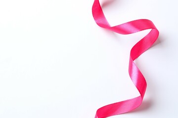 Pink satin ribbon isolated on a white background