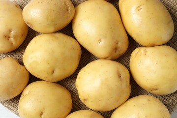 Young potatoes. Fresh potatoes on a wooden background. Harvesting collection. organic, freshly dug potatoes. Agricultural background. Vegan. Vegetables.Place for text.Copy space