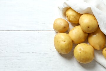 Young potatoes. Fresh potatoes on a wooden background. Harvesting collection. organic, freshly dug potatoes. Agricultural background. Vegan. Vegetables.Place for text.Copy space