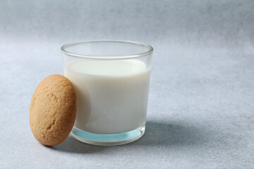 Glass of milk on gray background