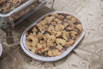 Elegant chafing dishes and food warmers with various meals served for catering reception in hotel or restaurant. Buffet served by the catering service company. 