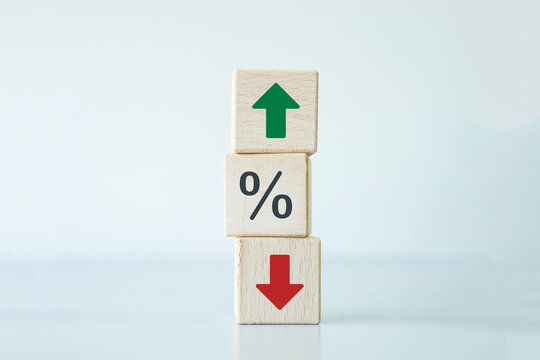 Wooden blocks with green arrow up and red down with percentage icon. Business planning for target achievement