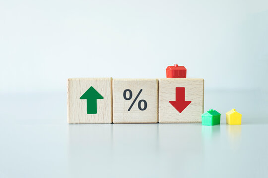 Wooden blocks with green arrow up and red down with percentage icon. Interest rate financial and mortgage rates concept