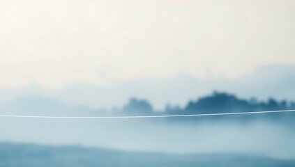 Misty morning landscape with a thin wire.