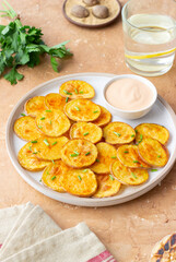 Baked potatoes with sauce. Homemade chips. Appetizer. Snack. Vegetarian food.