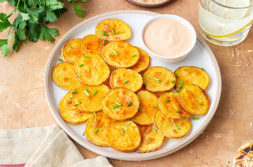 Baked potatoes with sauce. Homemade chips. Appetizer. Snack. Vegetarian food.