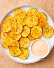 Baked potatoes with sauce. Homemade chips. Appetizer. Snack. Vegetarian food.