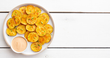 Baked potatoes with sauce. Homemade chips. Appetizer. Snack. Vegetarian food.