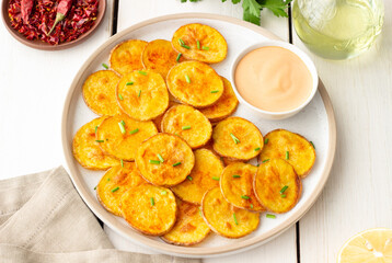 Baked potatoes with sauce. Homemade chips. Appetizer. Snack. Vegetarian food.