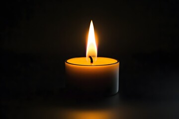 Single candle flame burning dark background, remembrance (3)