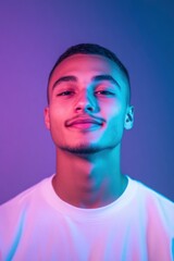 A happy young man wearing white t shirt against purple blue gradient neon light effect background
