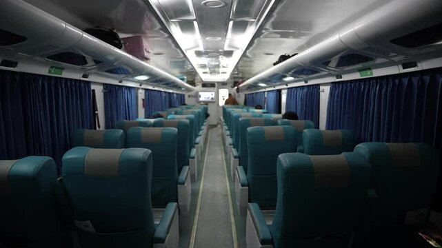 Empty seats on a passenger train in Indonesia at night.