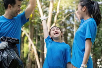 Joyful family celebrating after a successful volunteer garbage collection in the park