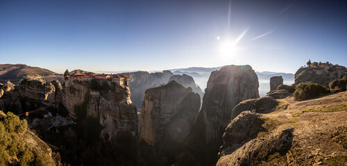 Sunset over Meteora. Amazing wide angle photo with the landscape of Meteora, iconic place with Greek orthodox monasteries in the mountains, during sunset. Travel to Greece.