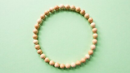 Elegant Wooden Bead Circle Frame on Pale Green Background for Design Projects