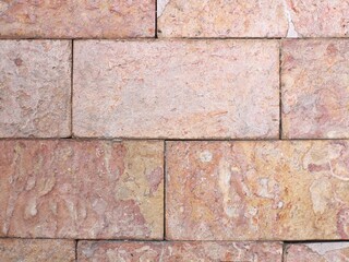 close up of smooth textured stone wall surface, stone wall background.