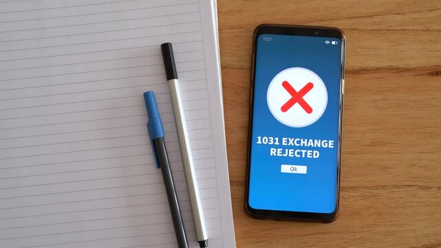 1031 exchange rejected notification on smartphone. Concept of problems with like-kind property exchange under IRC section 1031. Top view.