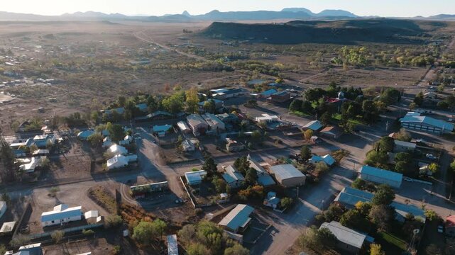 Rural Texas Town at Sunrise, Fort Davis in West Texas small town golden hour drone city orbit in 4k