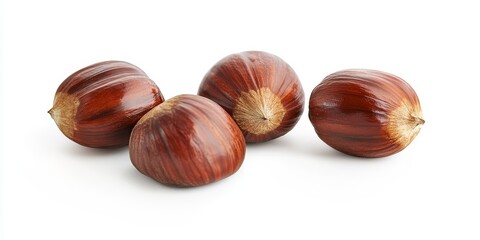 Obraz premium Isolated chestnuts on a white background showcase the unique texture and shape of chestnuts, highlighting their rich, earthy color and natural beauty in a clean visual format.