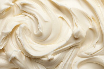 Smooth, creamy white frosting swirls together, creating a delectable texture perfect for cakes and desserts